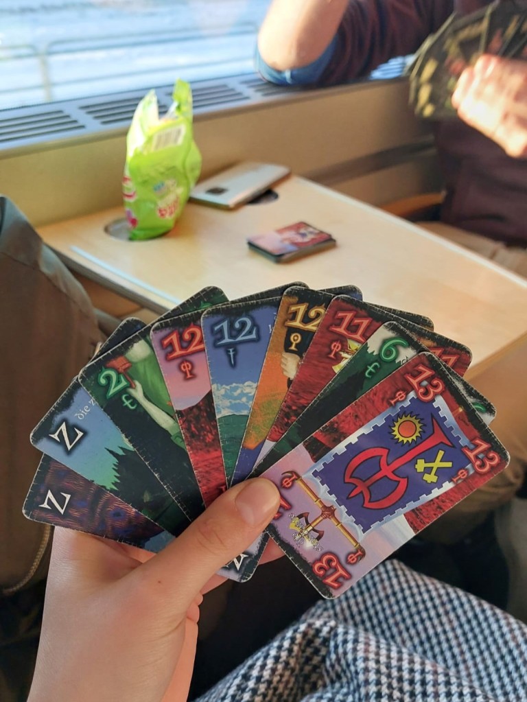 Anna (author) having a good deck of cards in a game. Photo in the train. Sunny.